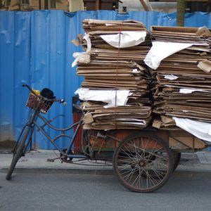 Tidying up. Photo of bicycle with a pile of cardboard.