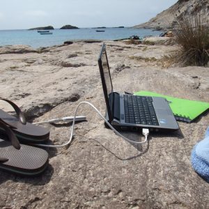 Planning and priorities. A laptop at the beach. 
